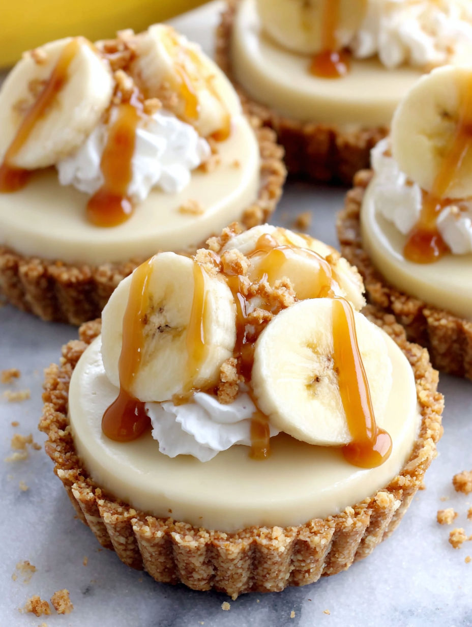 A close up of a banana cream pie with a drizzle of caramel.