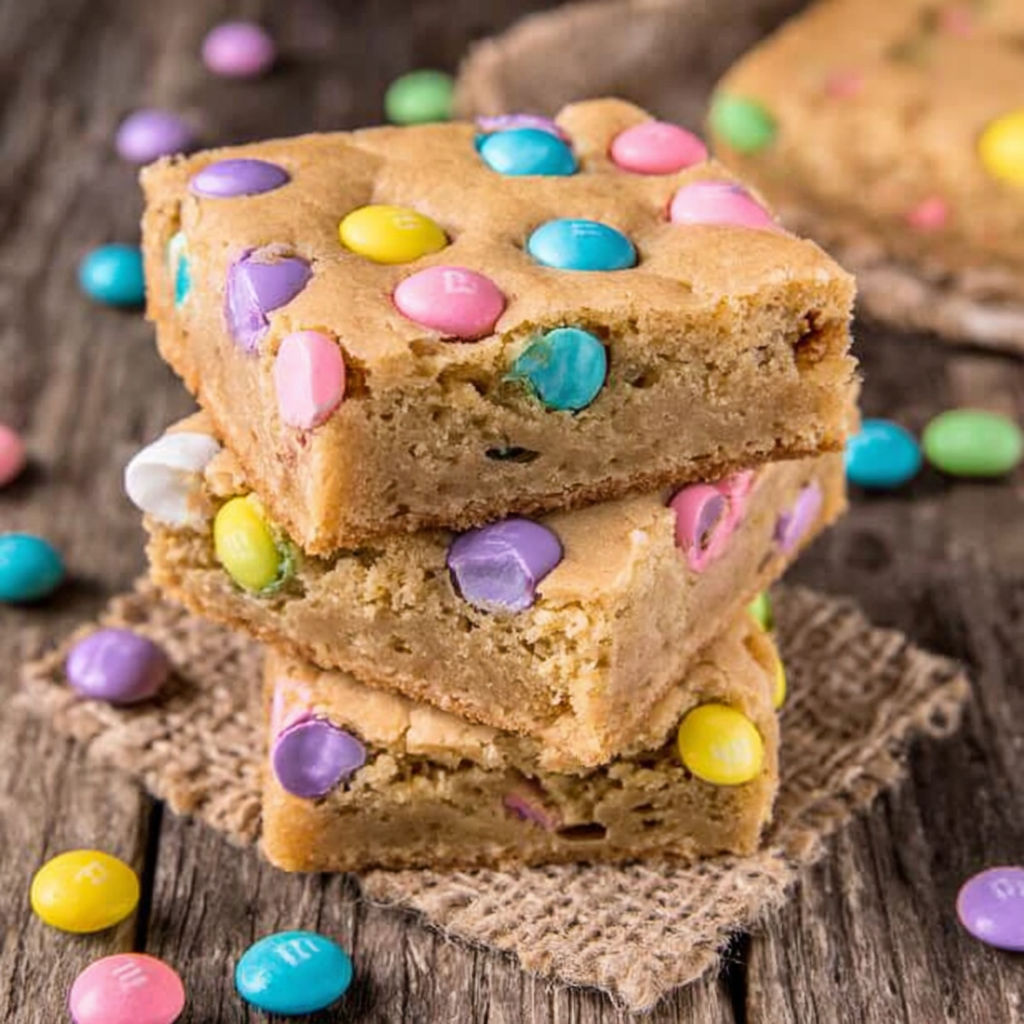 A stack of Easter blondies with colorful candies on top.