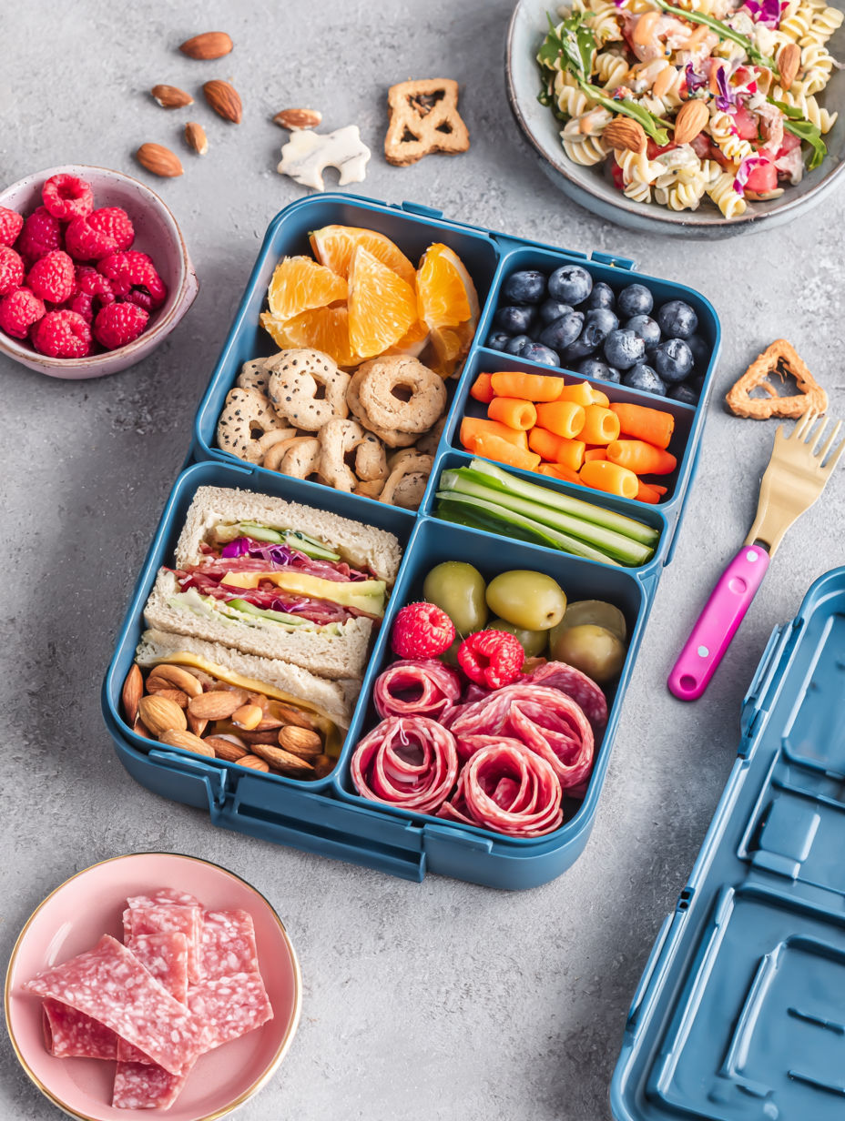 A blue lunch box filled with various foods.