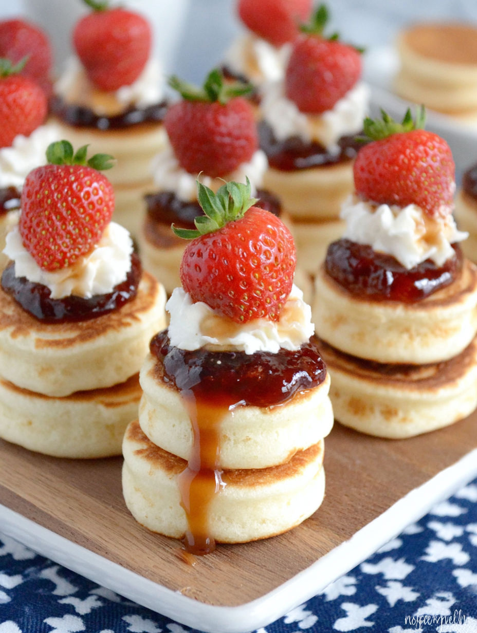 A plate of food with strawberries on top.