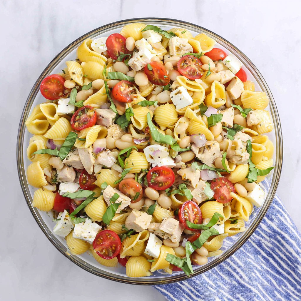 A bowl of pasta salad with chicken.