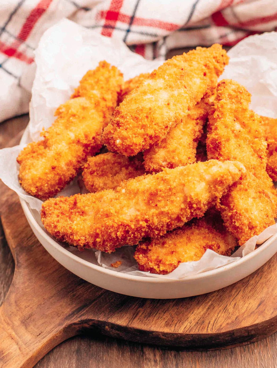 A bowl of breaded chicken.