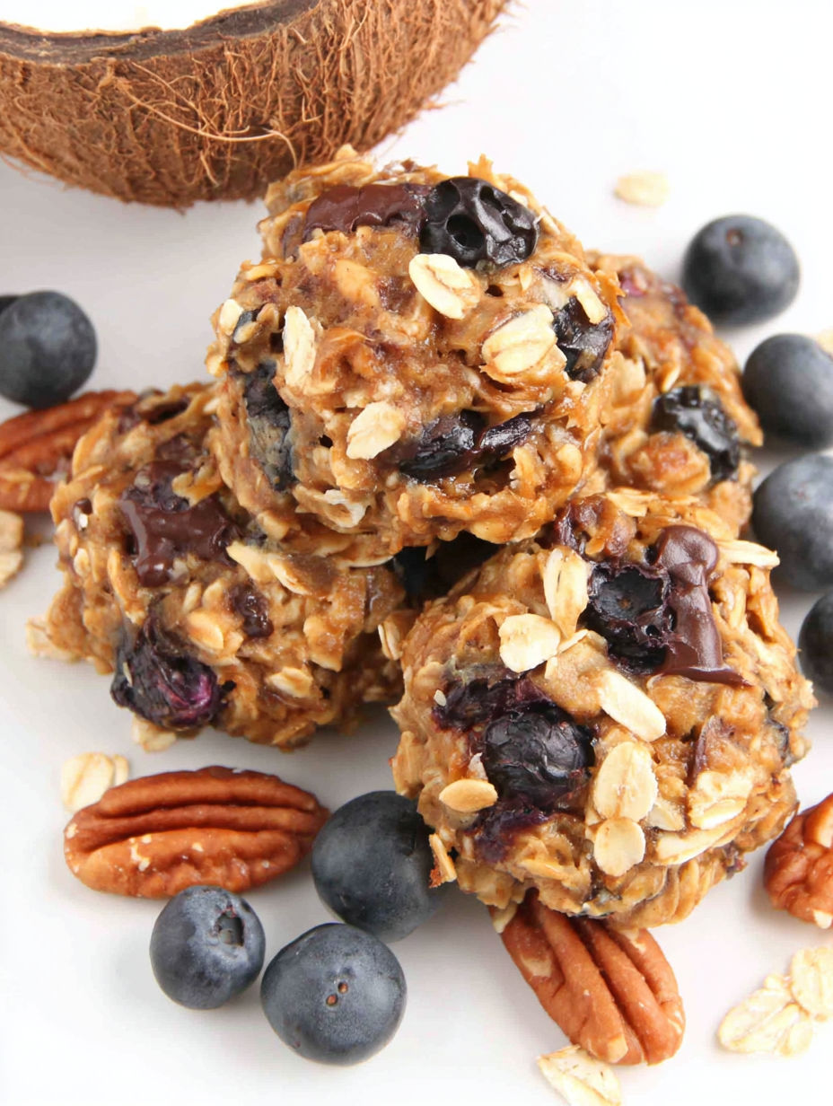 A plate of oatmeal cookies with blueberries on top.