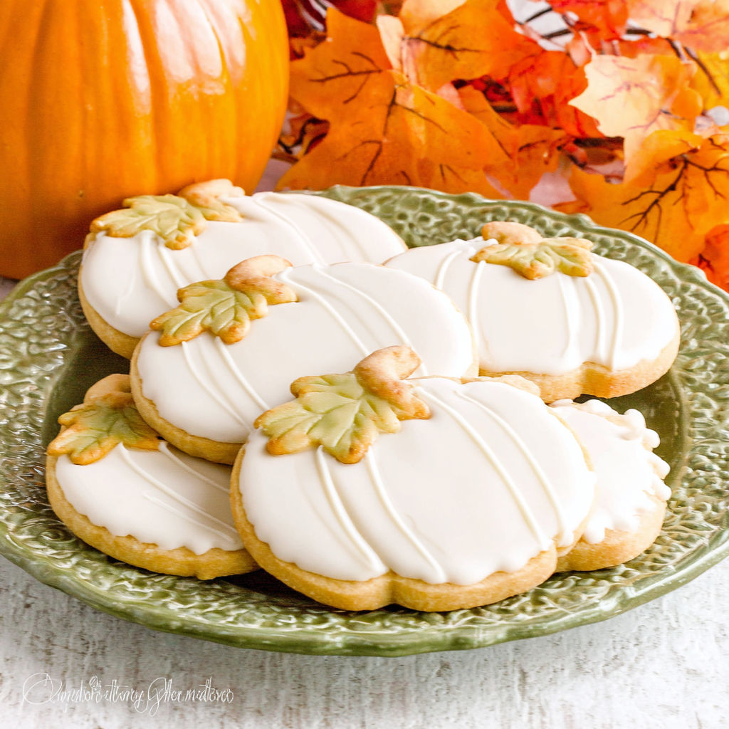 A plate of pumpkin spice sugar cookies with maple icing.