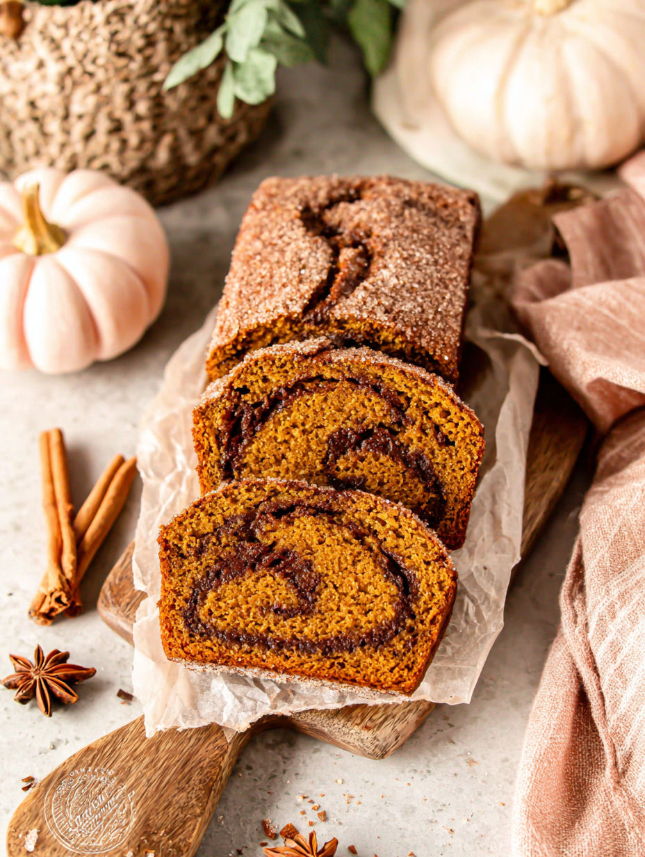 Three mini loaves of cinnamon swirl pumpkin bread.