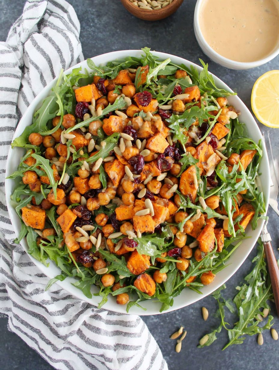 A bowl of roasted chickpea and sweet potato salad with a sweet tahini dressing.