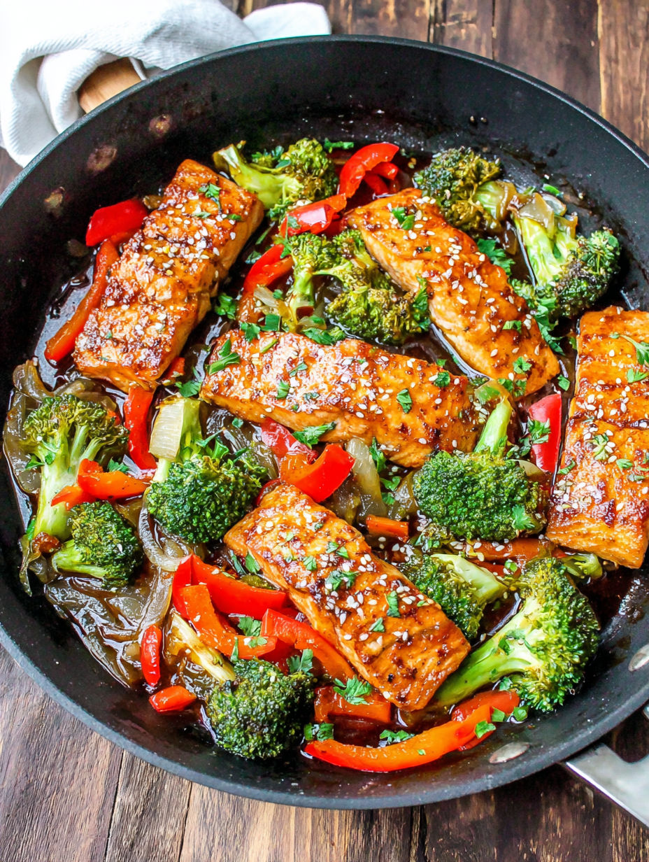 A pan of baked fish with broccoli and peppers.
