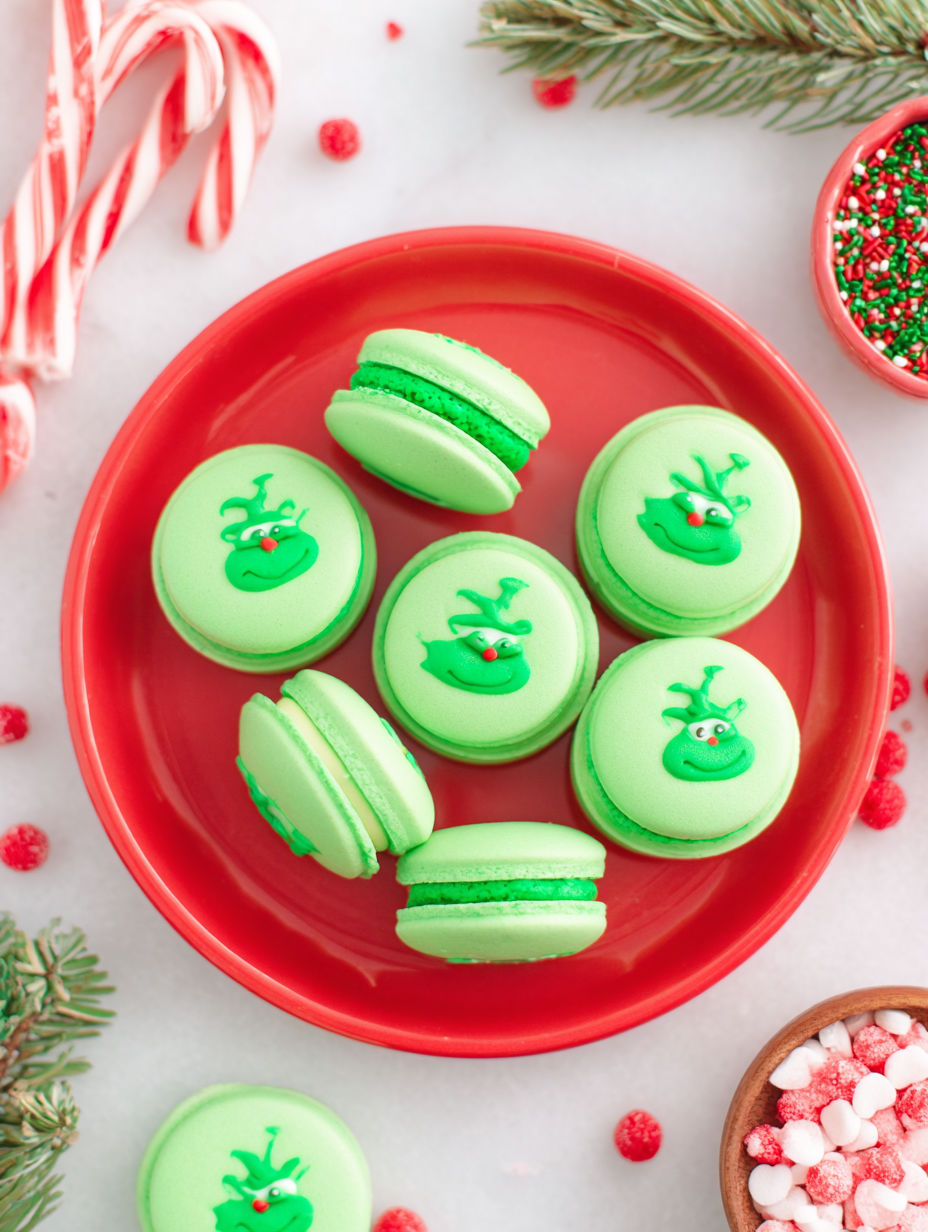 A plate of green and red cookies with a green frosting.