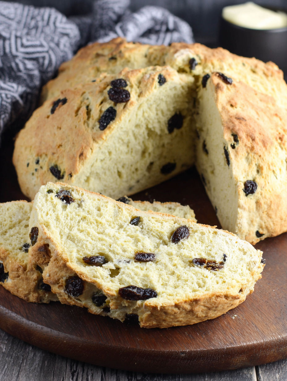 A slice of Irish soda bread with raisins.