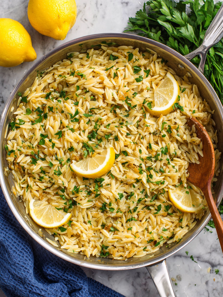 A bowl of rice with lemon and herbs.
