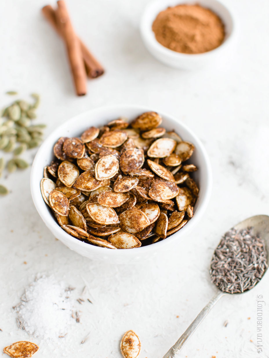 A bowl of pumpkin spice candied pumpkin seeds.