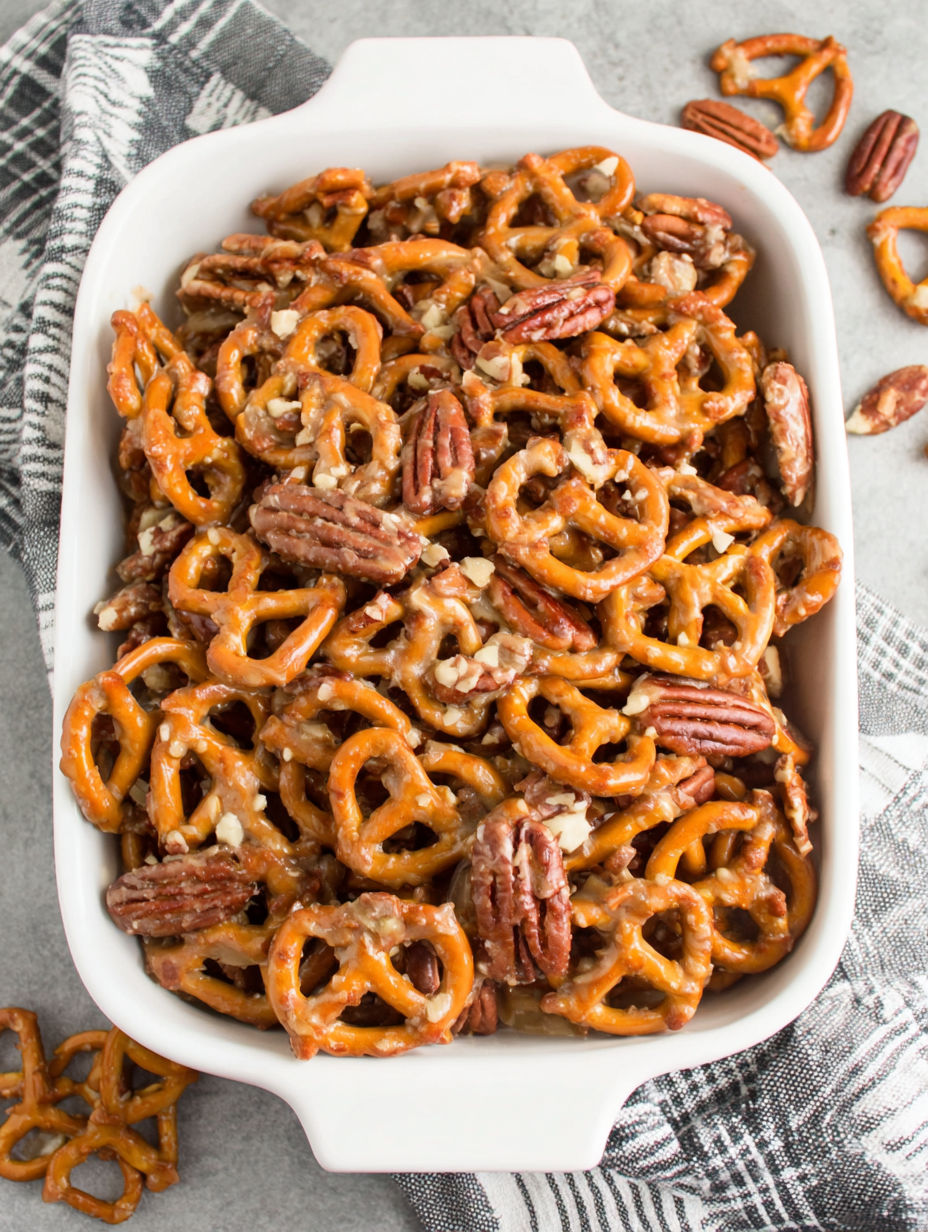 A white bowl filled with butter toffee pretzels.