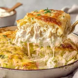 A skillet with white chicken enchiladas.