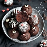 A bowl of chocolate truffles with white icing.