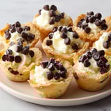 A plate of mini cannoli bites with white and brown toppings.