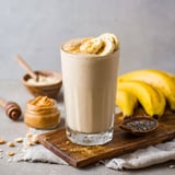 A glass of a banana protein smoothie with peanut butter.