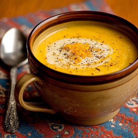 A cup of creamy butternut squash soup.