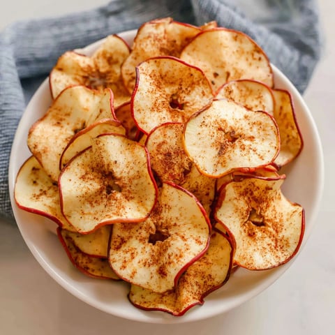 A bowl of apple chips with cinnamon.