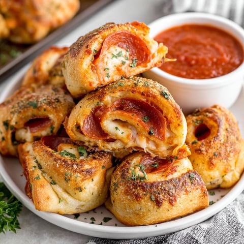 A plate of pepperoni pizza rolls.