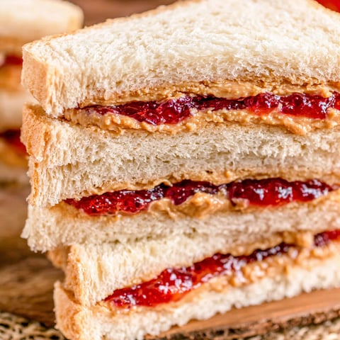 A stack of peanut butter and jelly sandwiches.