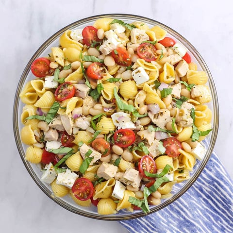 A bowl of pasta salad with chicken.