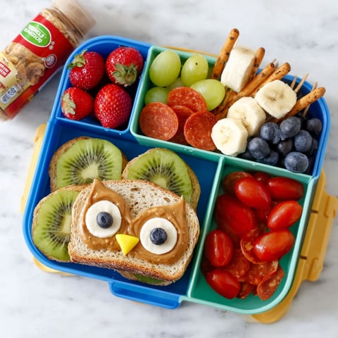 A fun lunch idea for kids with a sandwich, fruit, and vegetables.