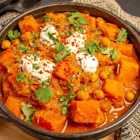 A bowl of pumpkin curry with chickpeas and coconut.