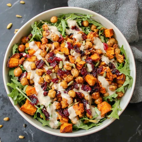 A bowl of roasted chickpea and sweet potato salad with sweet tahini dressing.
