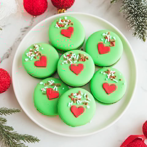 A plate of green heart shaped cookies.