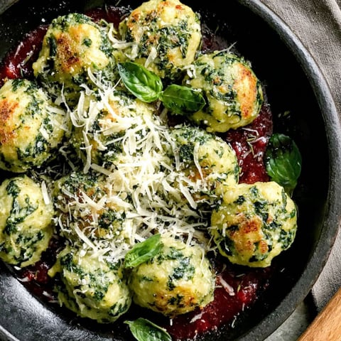 Malfatti dumplings covered in cheese and herbs.