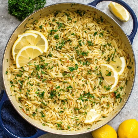 A pan of rice with lemon and herbs.