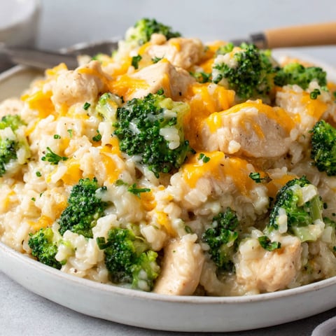 A plate of rice, chicken, and broccoli.